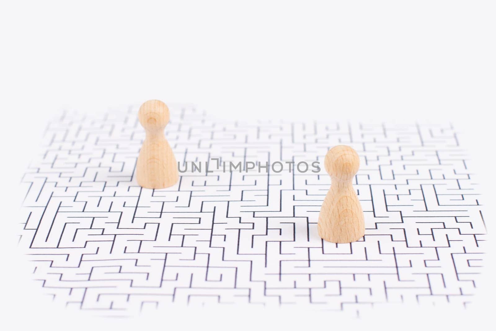 Men stand in the middle of a labyrinth, searching for a solution to exit, finding a strategy, challenge and problem solving concept