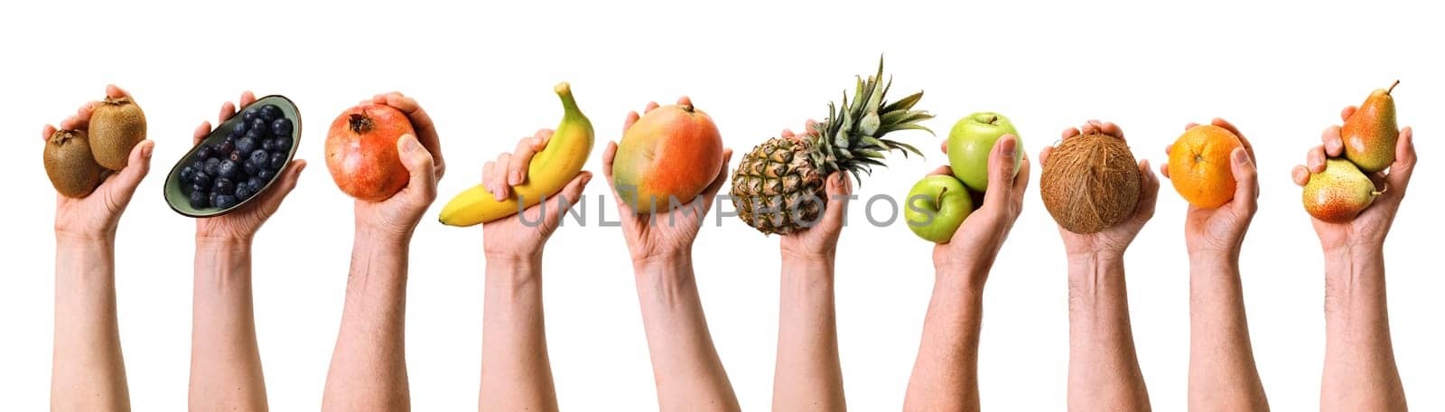 Hands of crop anonymous people holding various ripe fruits and berries on white background during harvesting season in light studio