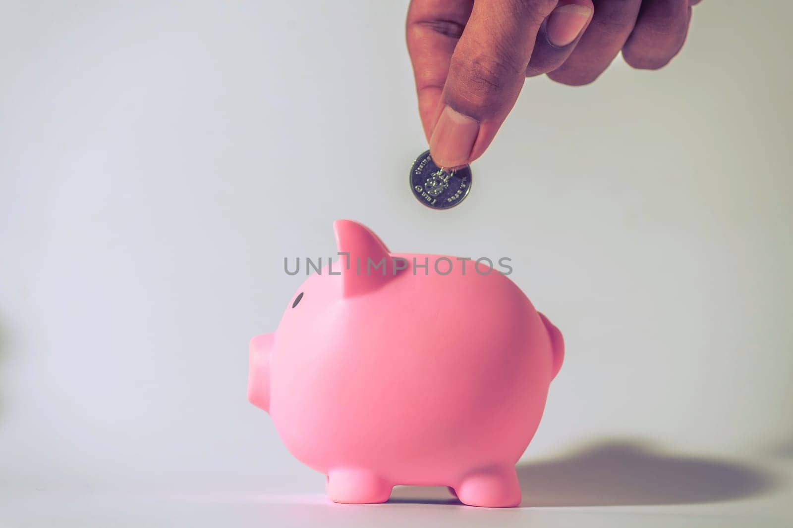 Save money and account banking for finance concept, Hand with piggy bank and coin on blurred background, Save Monney for Investors Using Internet to Trade Stocks or Trade Fund