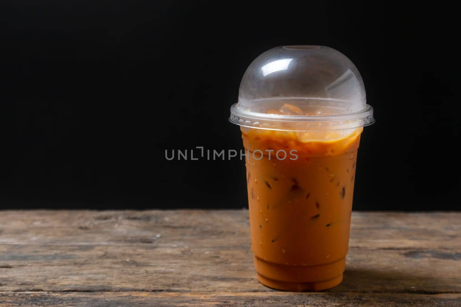 Tea thai, Ice tea milk or Ice milk tea, Sweet drink, Blurred black background
