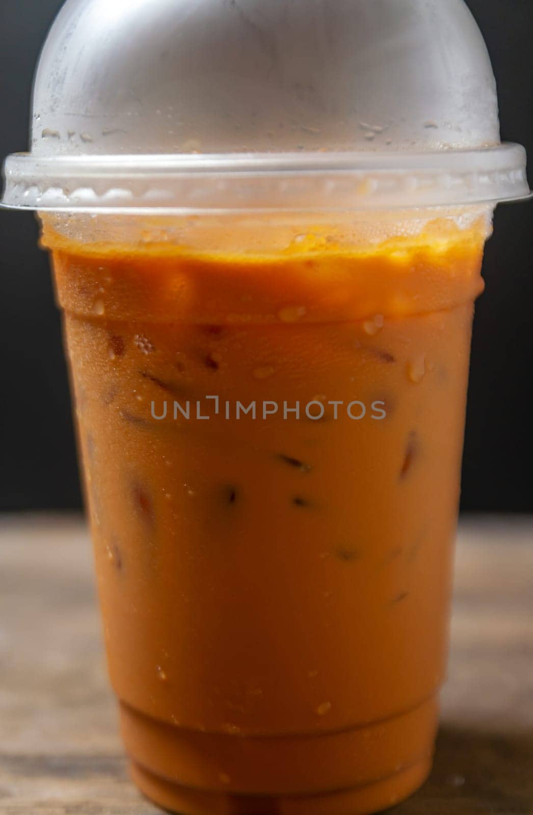 Tea thai, Ice tea milk or Ice milk tea, Sweet drink, Blurred black background
