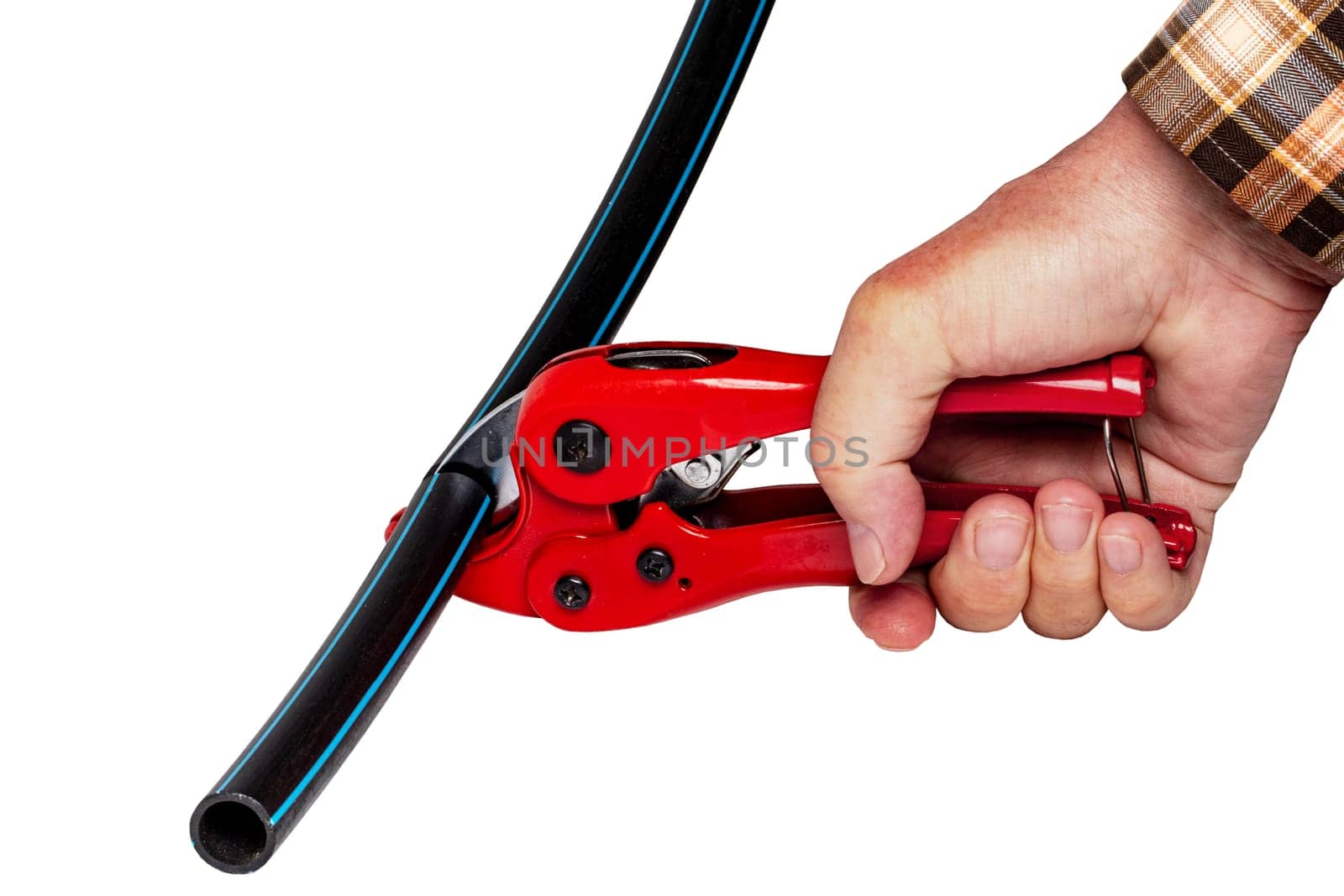 Plumber tools isolated. A man accurately cuts a piece of PE pressure pipe or water pipe with a red pvc pipe cutter. Clipping path. Drinking and service water systems.
