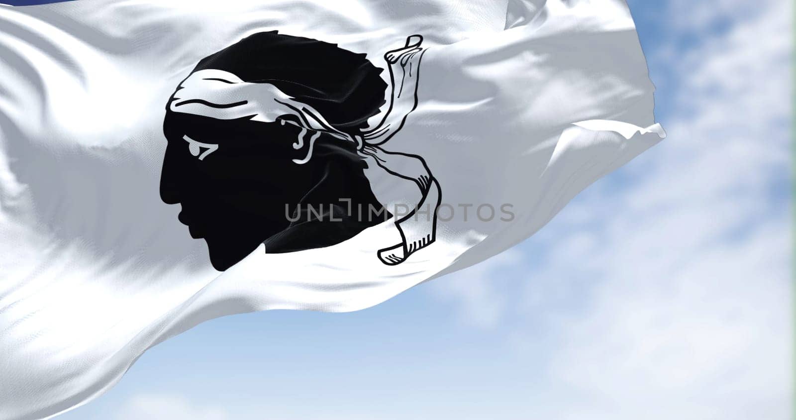 The flag of Corsica waving in the wind on a clear day. The Corsica is an island of the Mediterranean Sea and French administrative region
