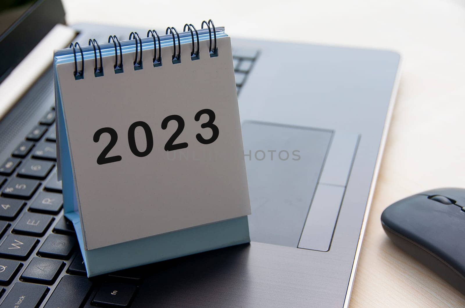 New year 2023 text on calendar desk on top of a laptop - New year concept