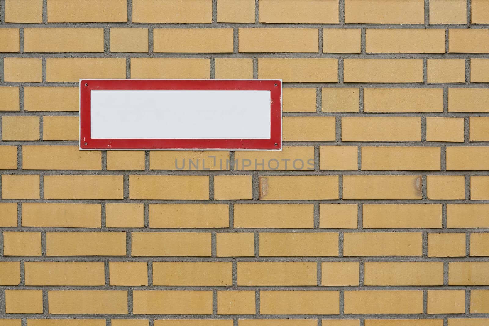 blank white sign with text free space on brick wall