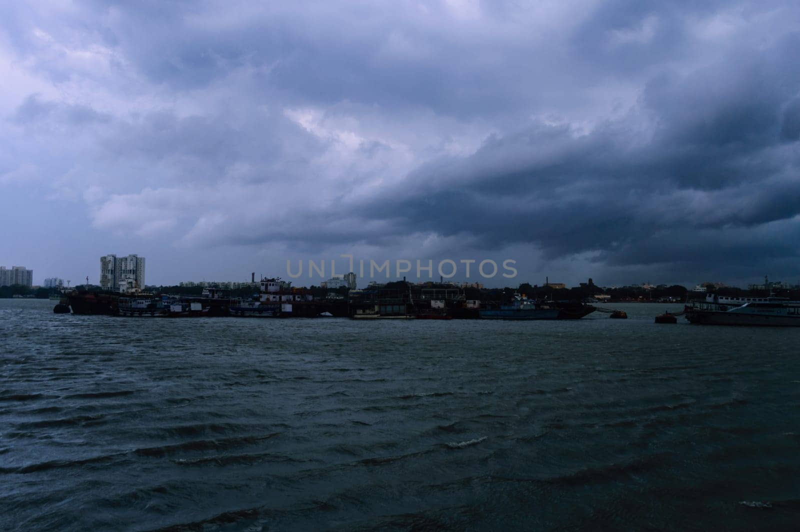 Kolkata Riverside Landscape View on a Dark cloudy day. View from Babu Ghat Footbridge. Kolkata West Bengal India South Asia 19 June 2022
