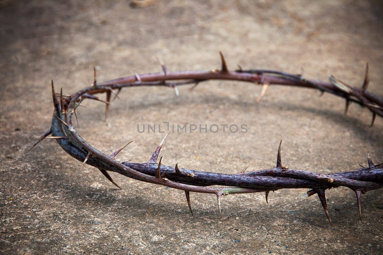 Copy space for Christian prayer text or quote with crown of thorns on floor rock. Copy space