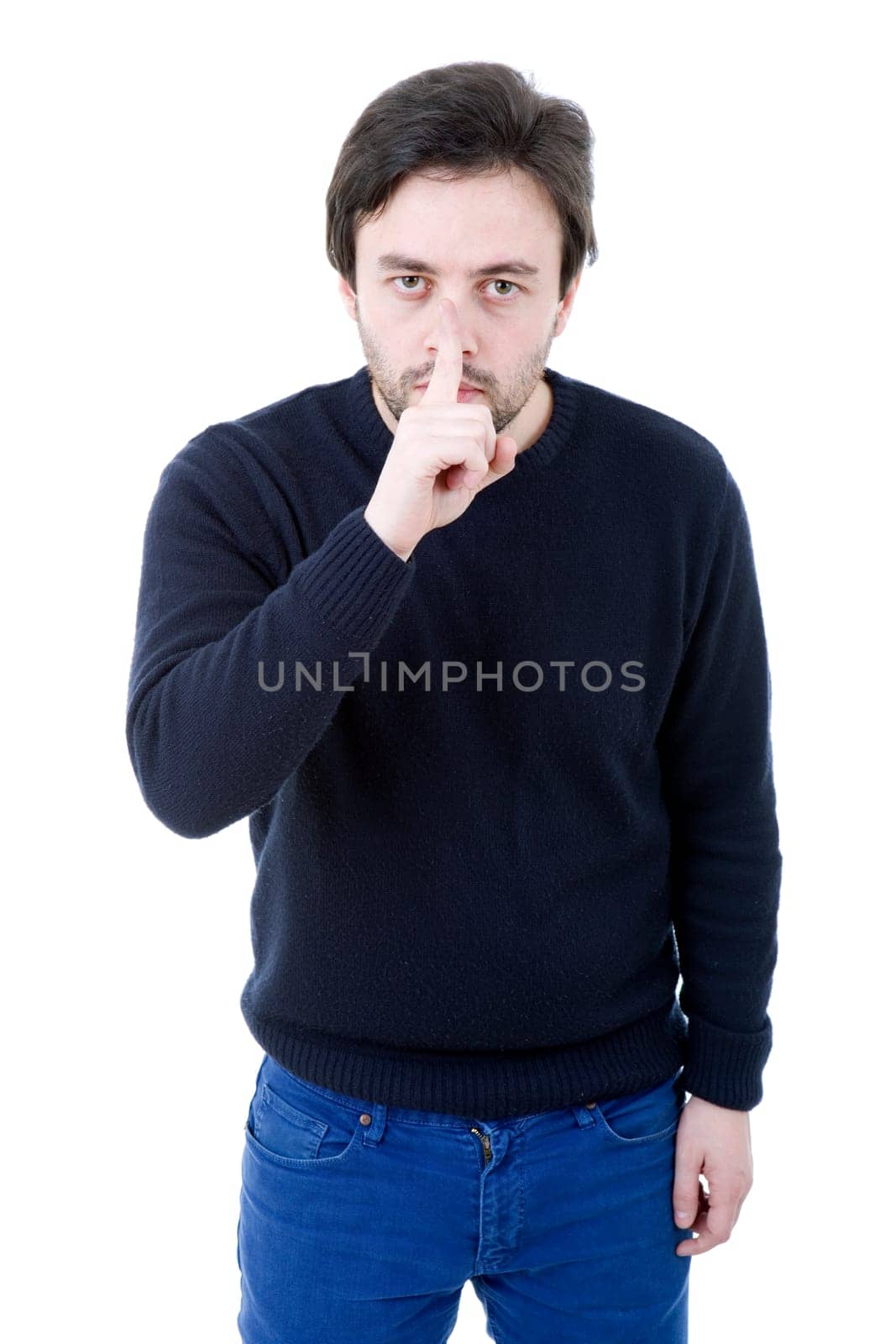 young man showing silence gesture with his finger in the mouth
