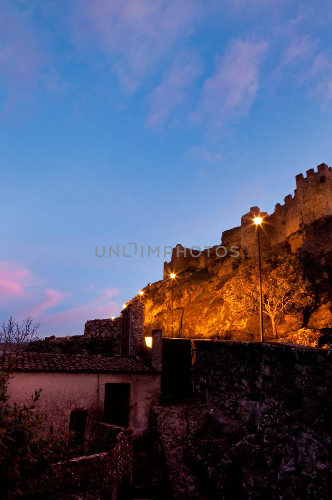 Old castle remains of Montanchez Lighted with the last ray of light at sunset, Spain