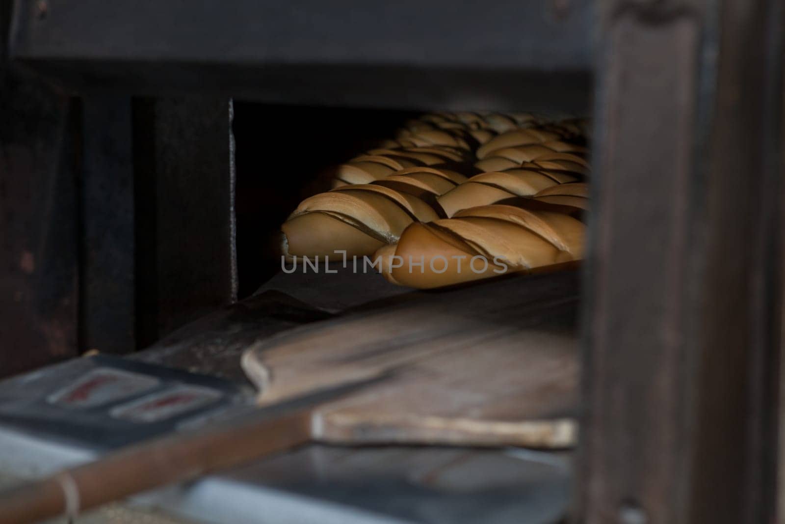 Oven inside plenty of bread. Manufacturing process of spanish bread