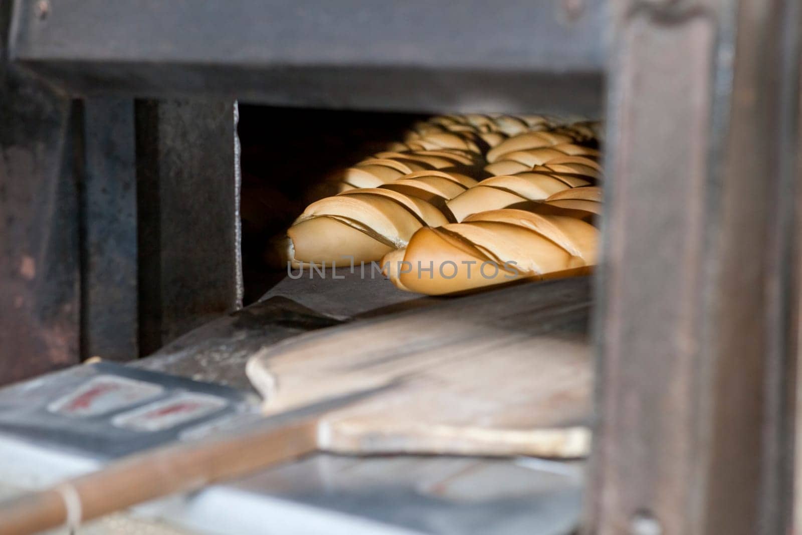 Oven inside plenty of bread. Manufacturing process of spanish bread
