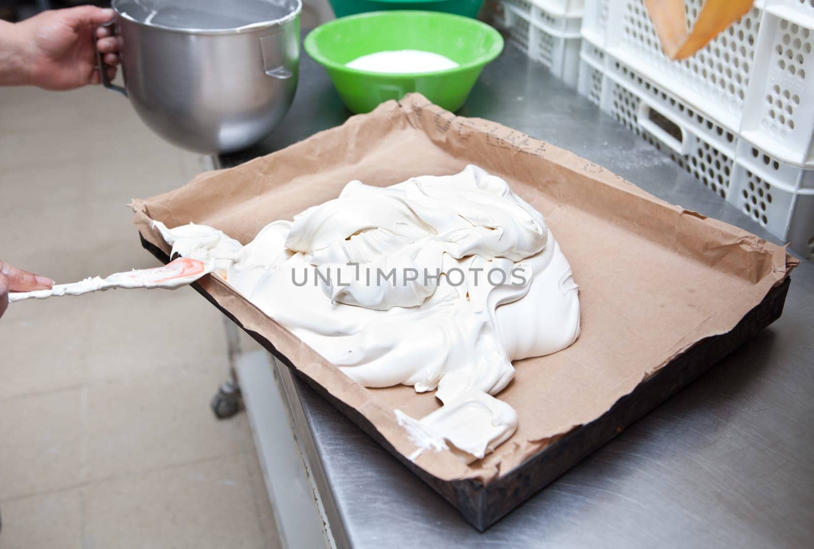 Baker preparing the sponge cake dough. Manufacturing process at bakehouse