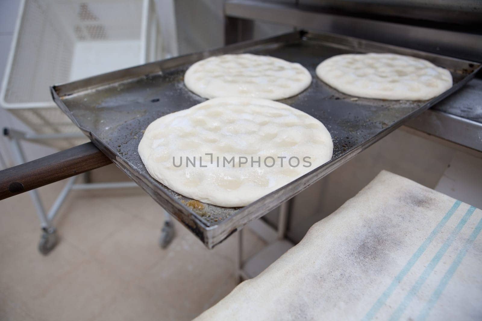 Elaboration process of traditional spanish olive oil pancakes. Pancakes ready for baking