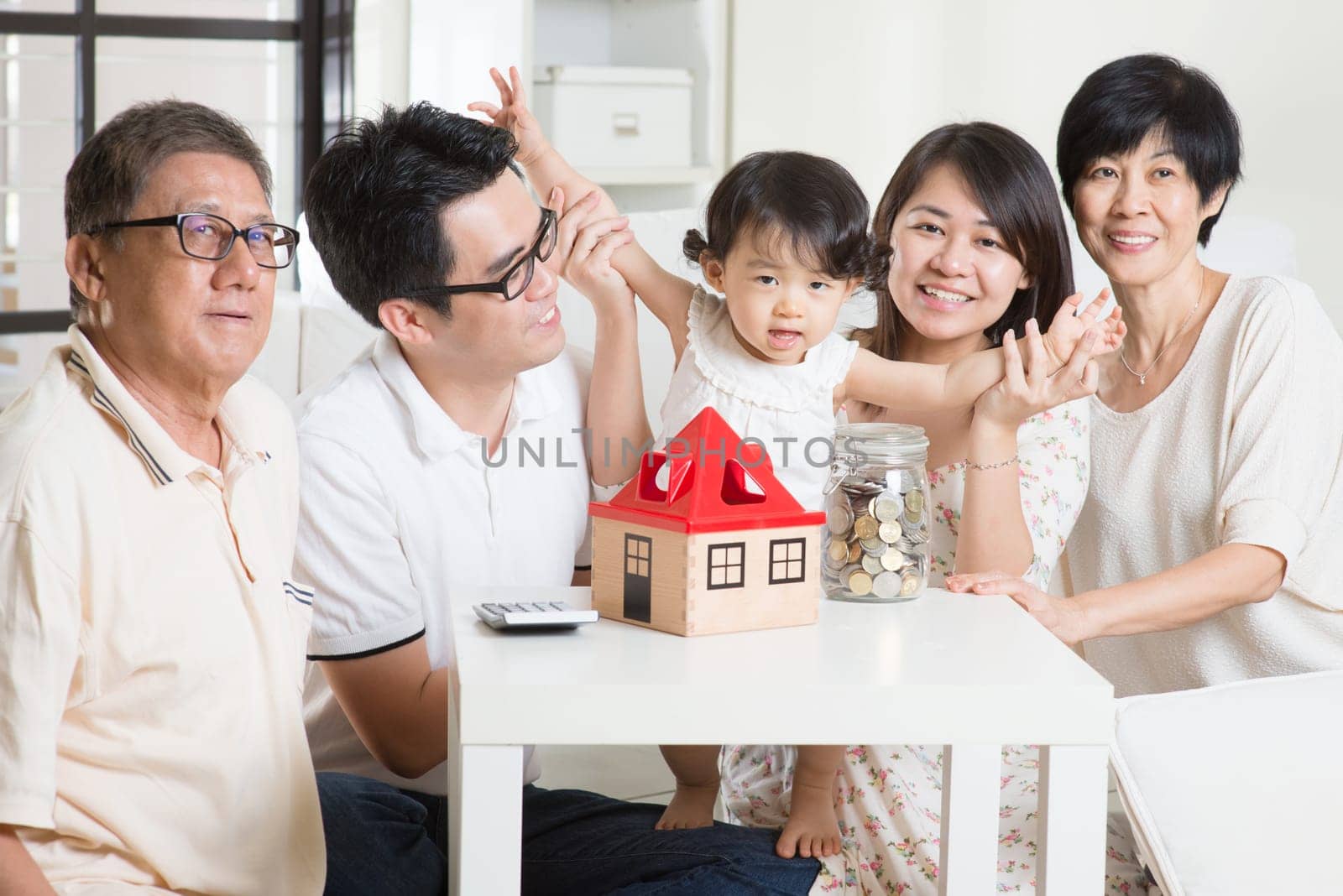 Family money saving or future financial planning concept. Asian multi generations lifestyle at home.