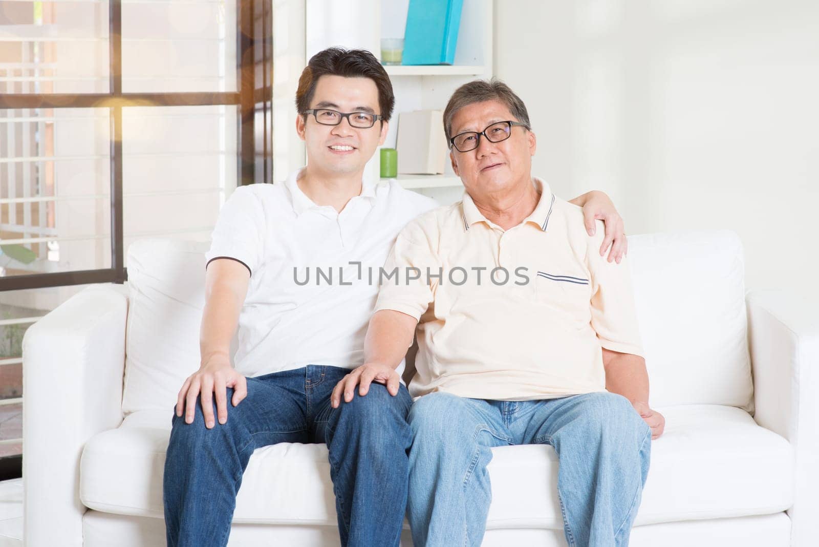 Asian senior father and adult son at home. Family living lifestyle.