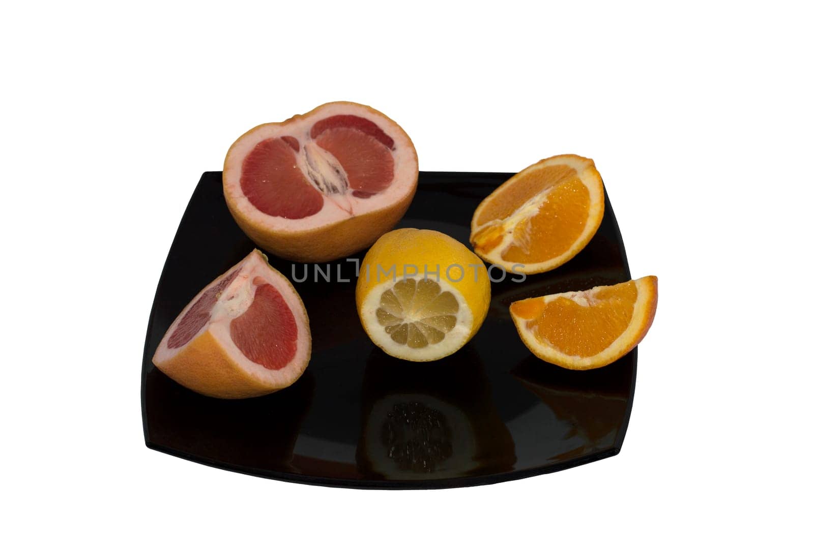 the grapefruit, lemon and orange cut on a big plate