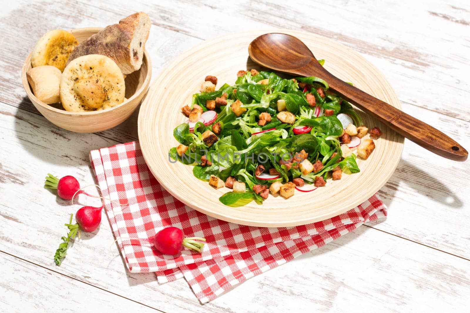 Field salad with bacon cubes,croutons and radishes,studio