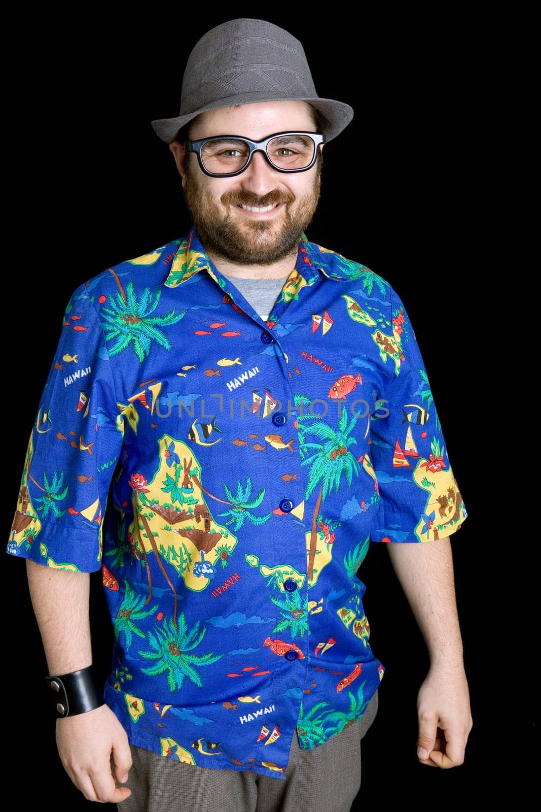 young happy man with a hawaiian shirt on black background