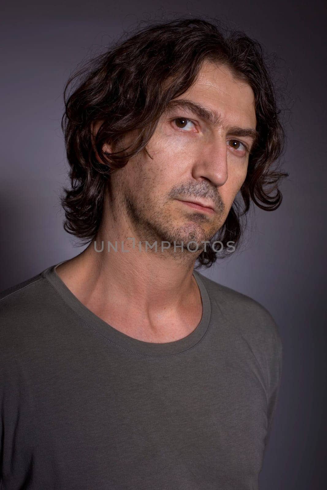 young casual man portrait in a dark background