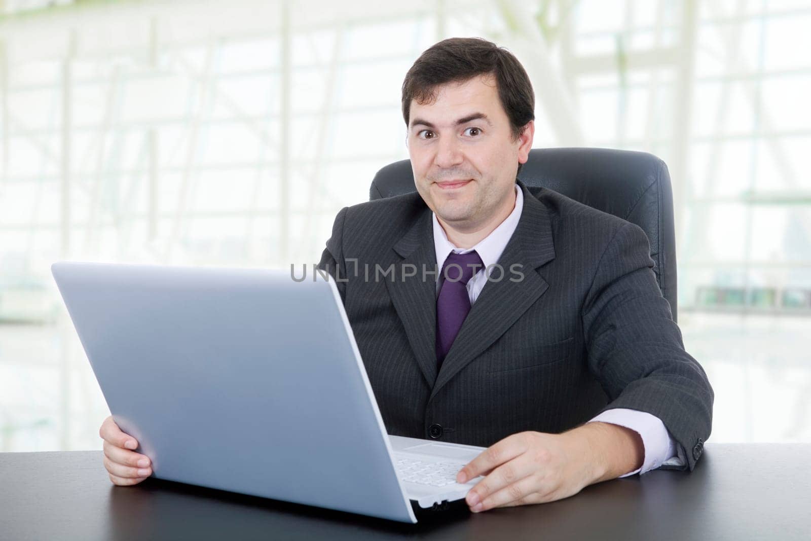 young businessman working with is laptop, at the office