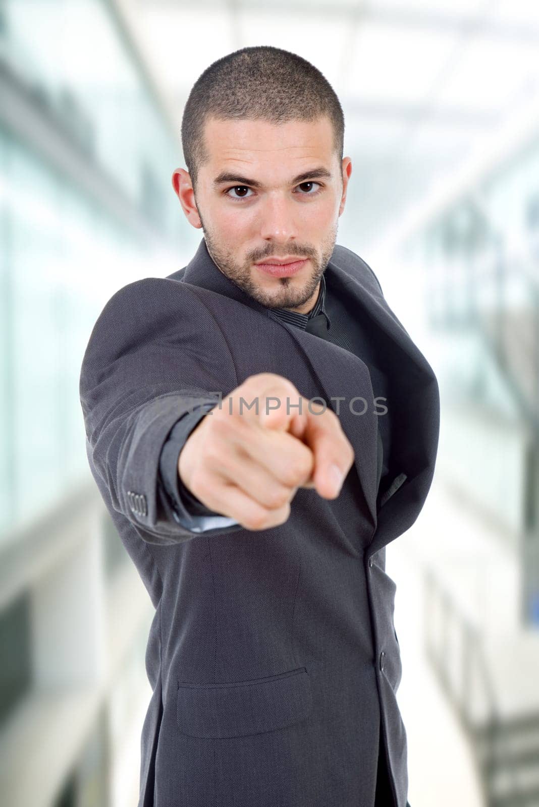 young business man in a suit pointing with his finger