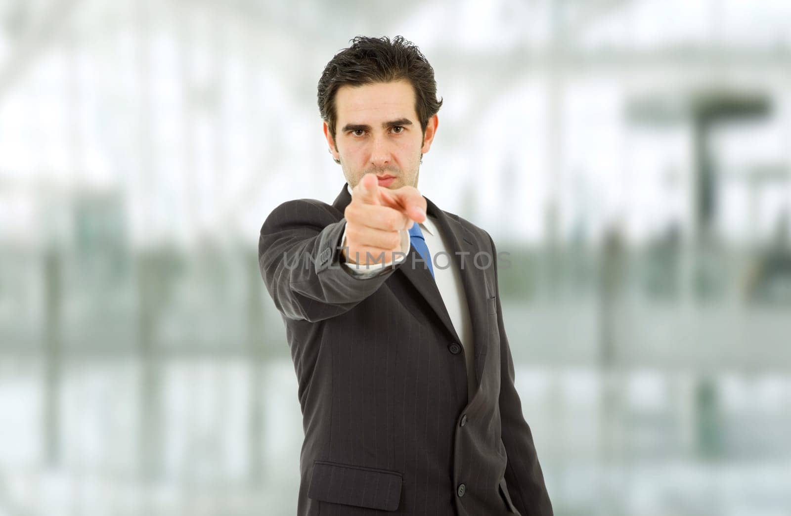 young business man in a suit pointing with his finger