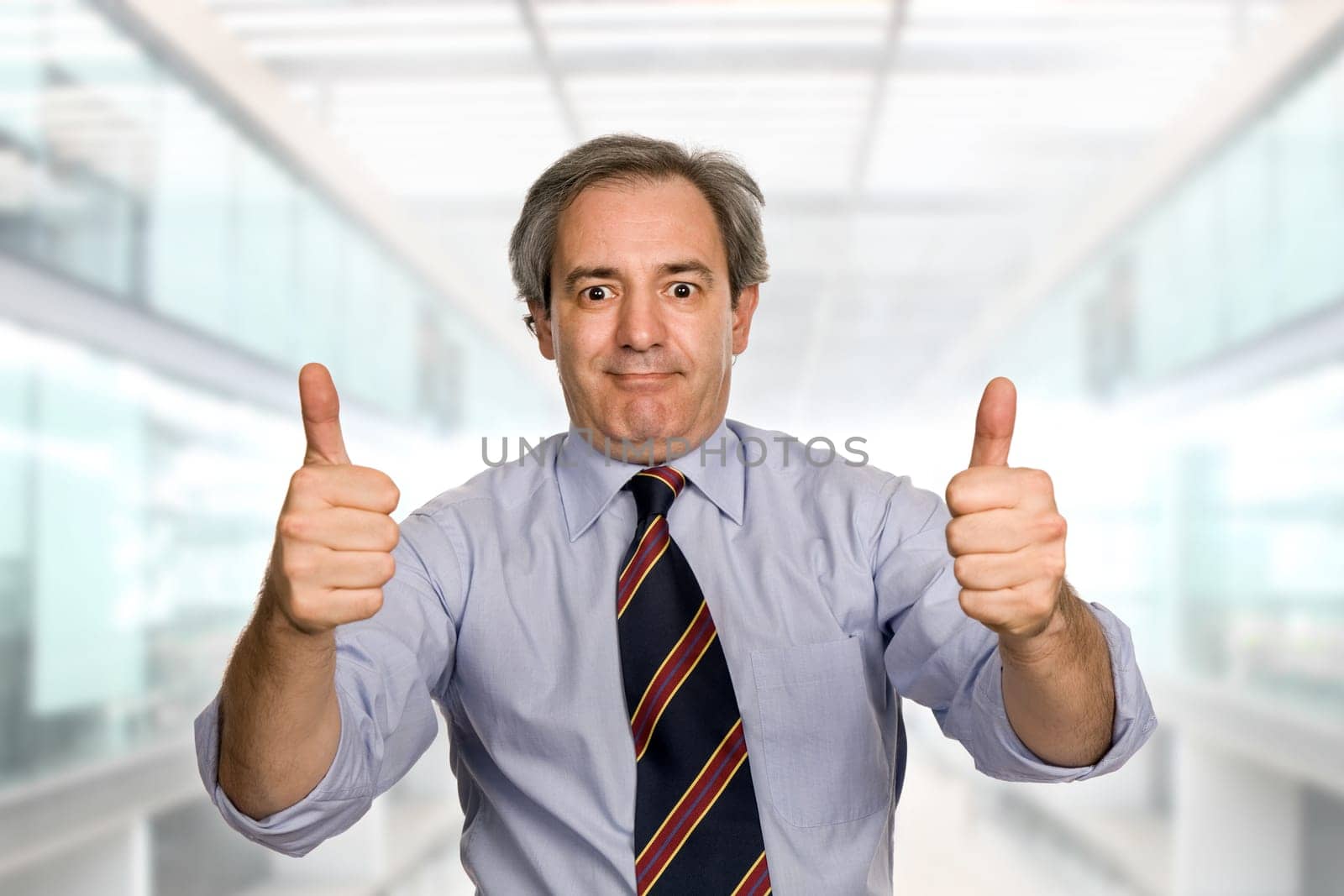 business man going thumbs up at the office