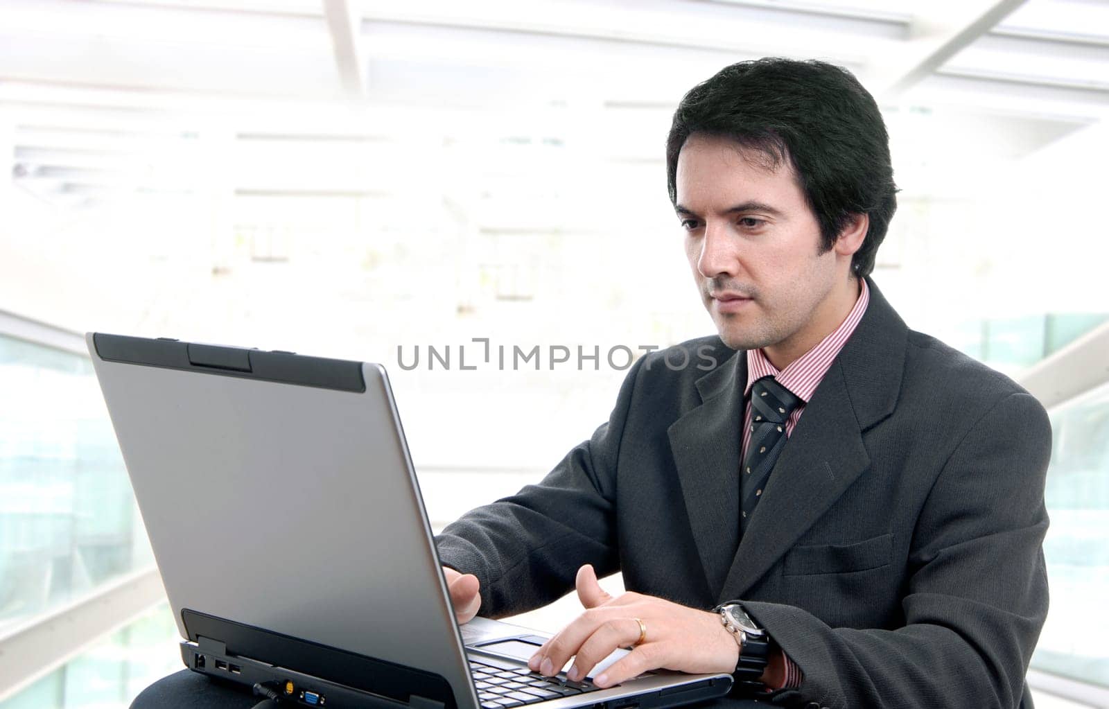 young man and working with is laptop