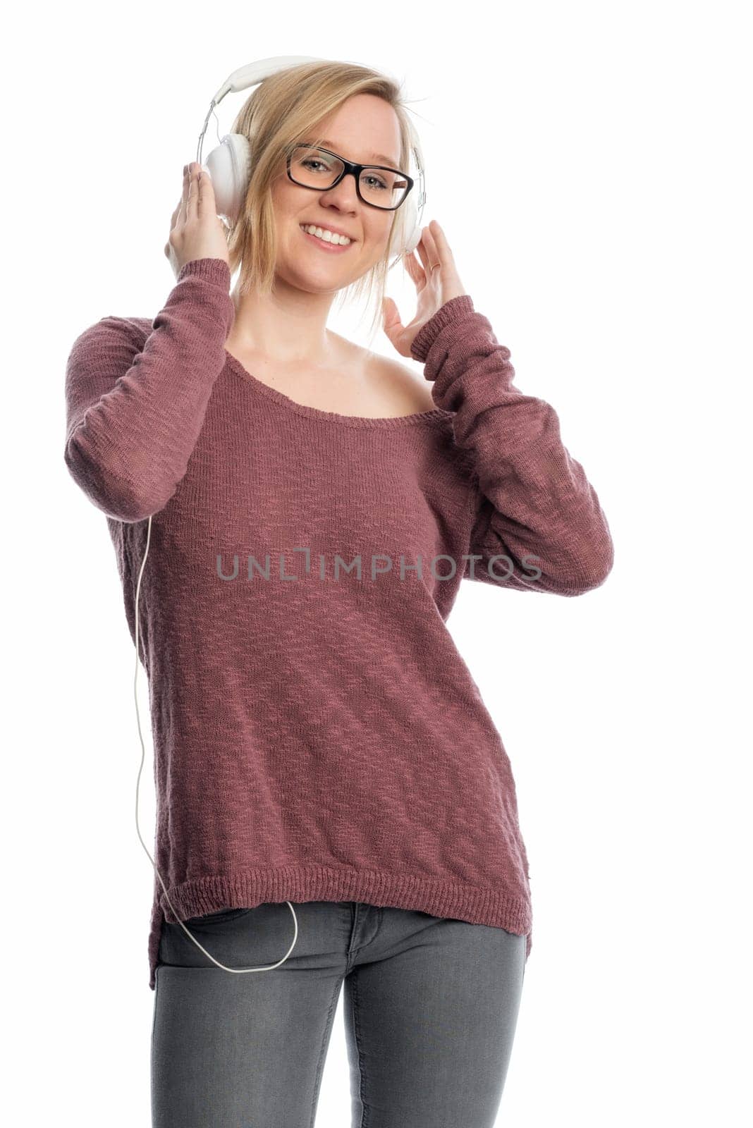 Young woman with glasses wearing headphones