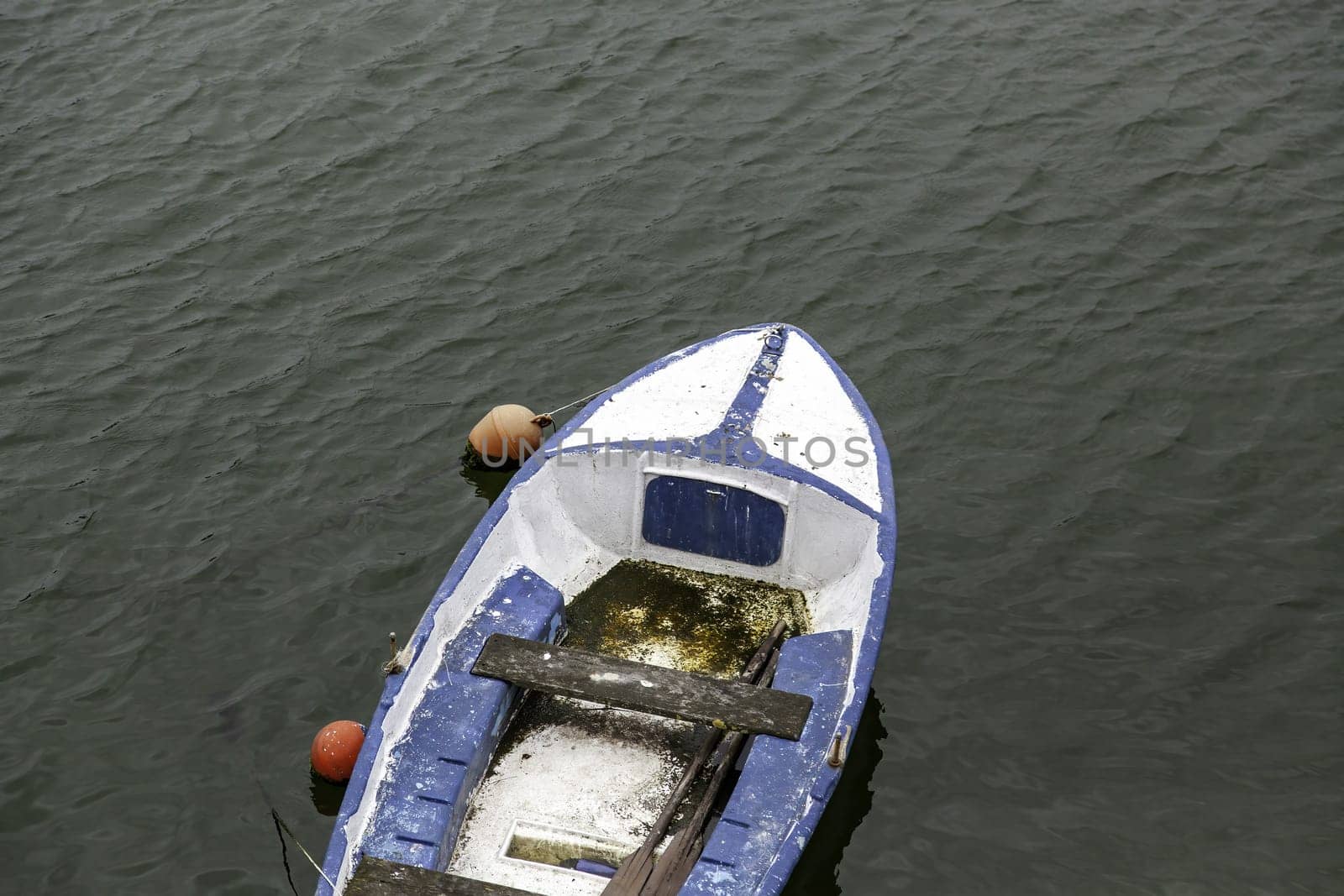 Detail of old fishing boat in the sea, abandoned