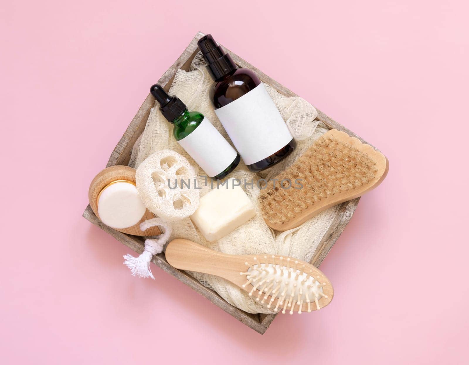 Tray of Natural cosmetics and accessories on pink top view, copy space. Brand package mockup. Natural beauty products for hair and skin care, Top view