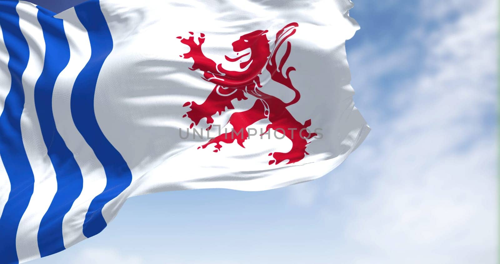 The flag of Nouvelle-Aquitaine waving in the wind on a clear day. Nouvelle-Aquitaine is the largest administrative region in France