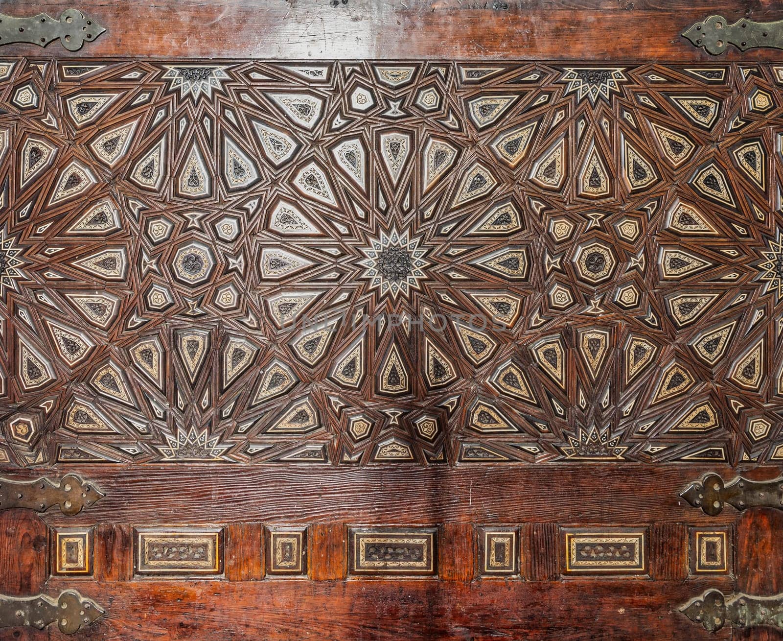Wooden arabesque decorations tongue and groove assembled, inlaid with ivory and ebony, at Quran reading bench, at historic public Mosque of Al Rifai, Cairo, Egypt