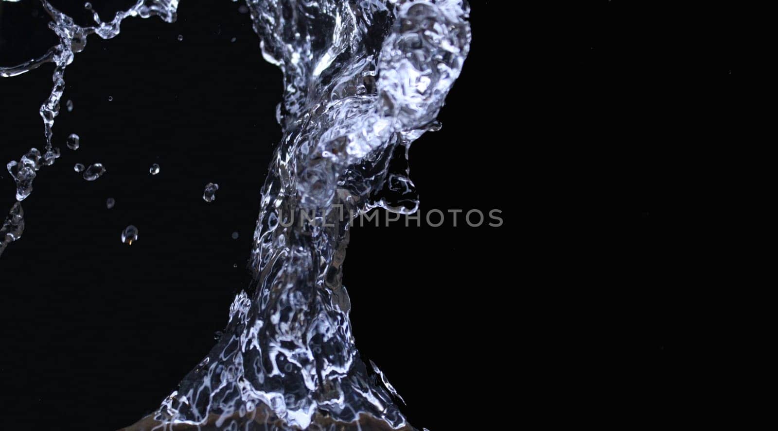 Isolated splashes of water on a black background. Abstract background. Ecological concept...