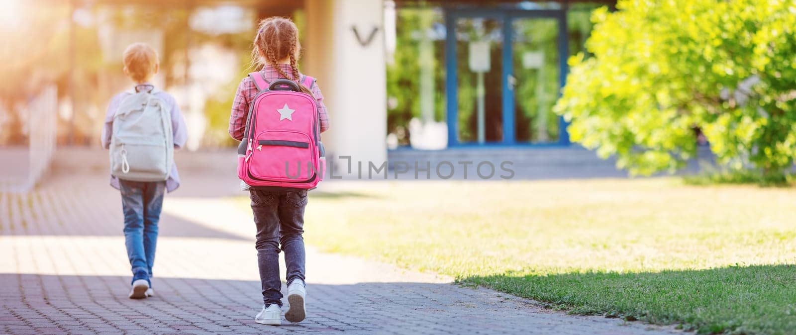 Girl and boy going to the school to study at it. Concept of back to school and friendship.
