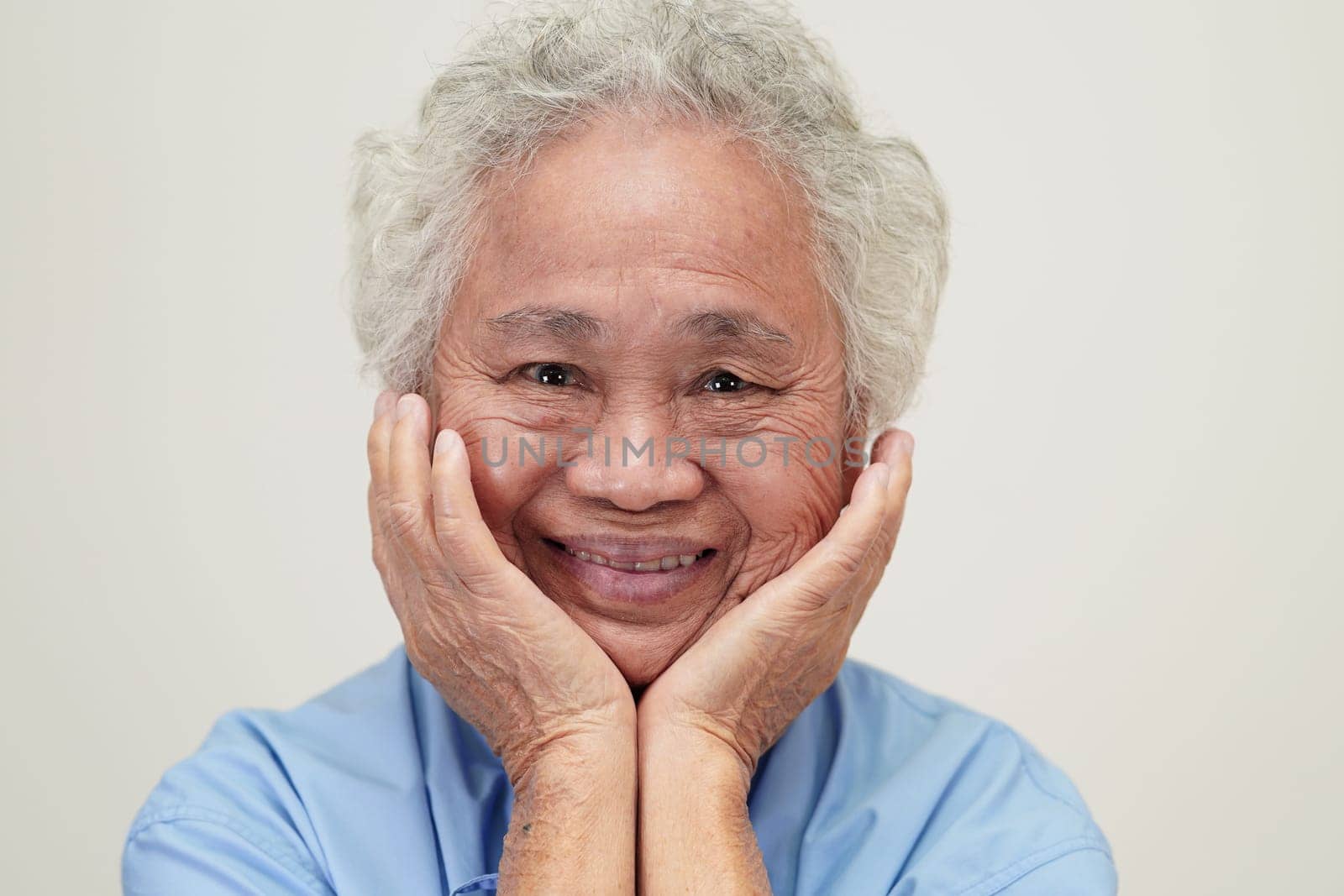 Asian elder senior woman patient sitting and smile face with happy on bed in hospital.
