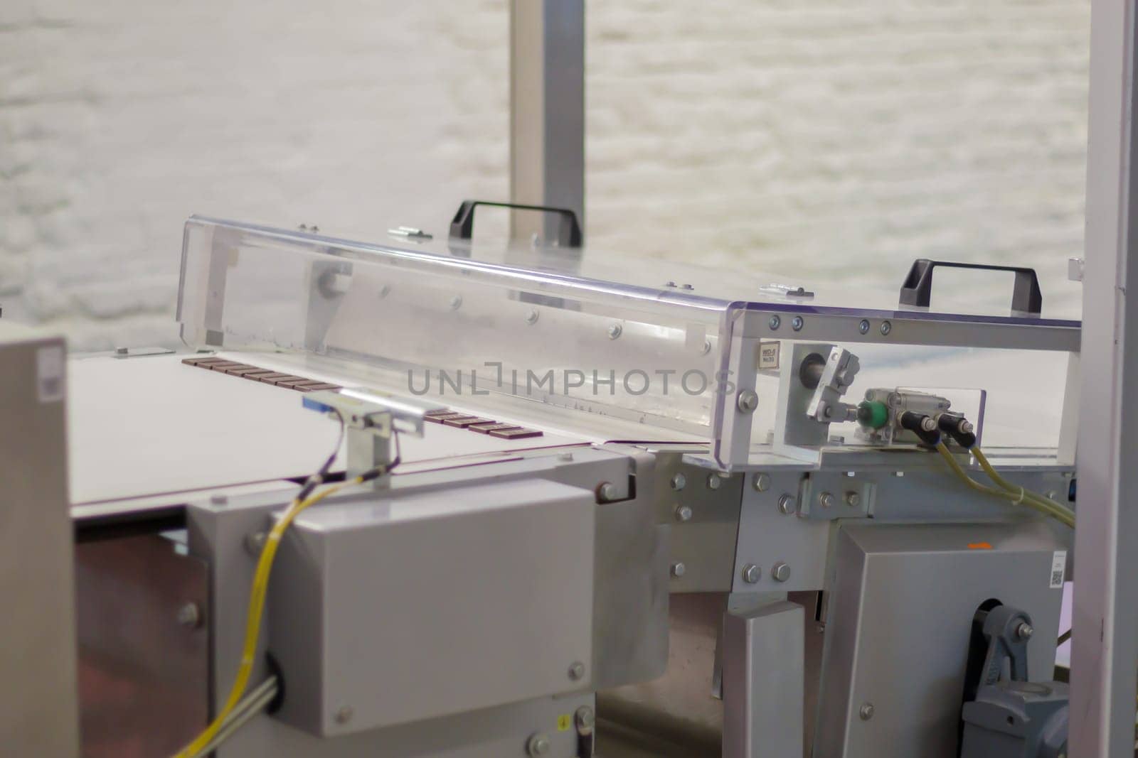 Line for the production of chocolate in an industrial factory. Automatic process in the production line of sweets. Images from the chocolate factory during production. Conveyor belt with sweets