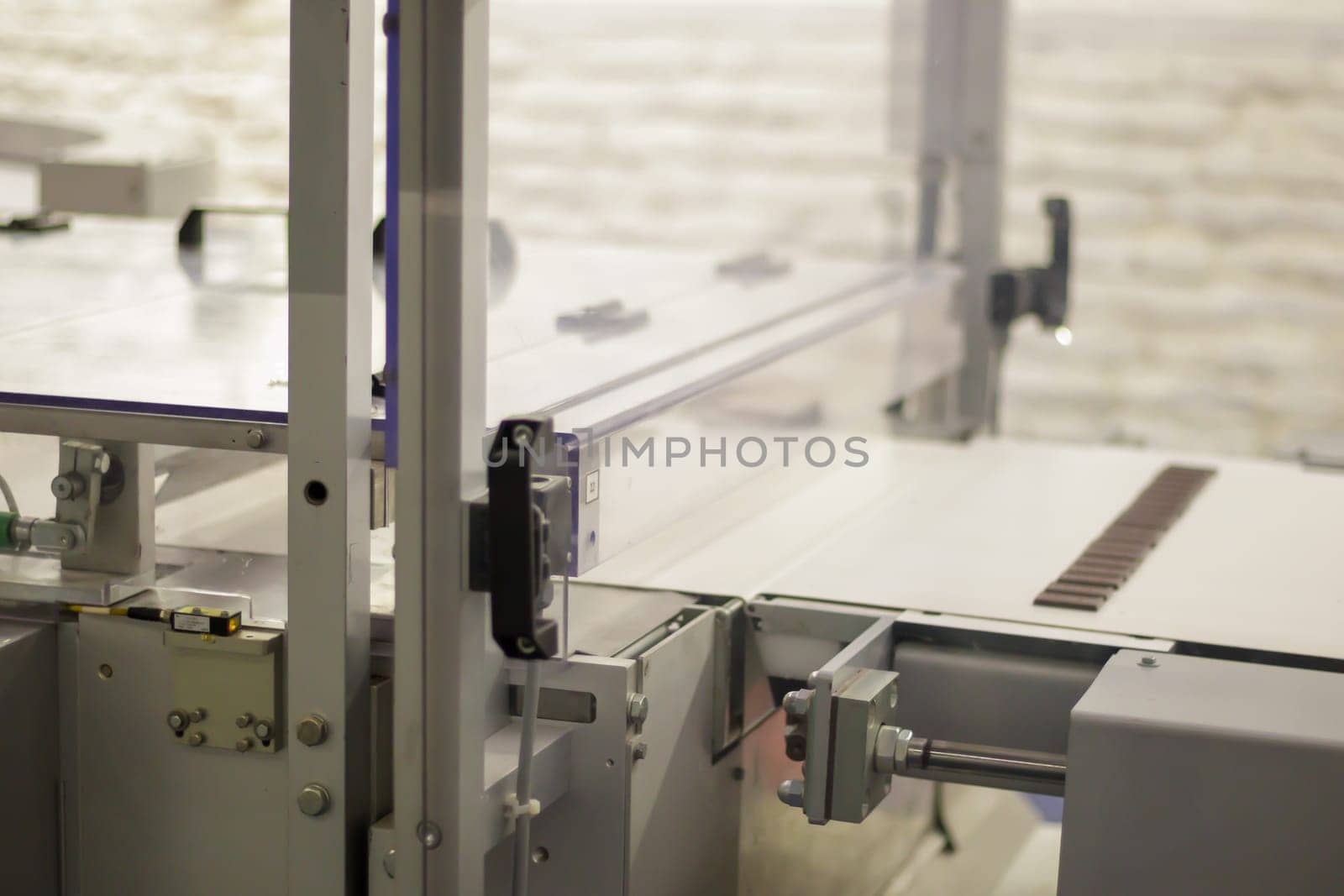 Line for the production of chocolate in an industrial factory. Automatic process in the production line of sweets. Images from the chocolate factory during production. Conveyor belt with sweets
