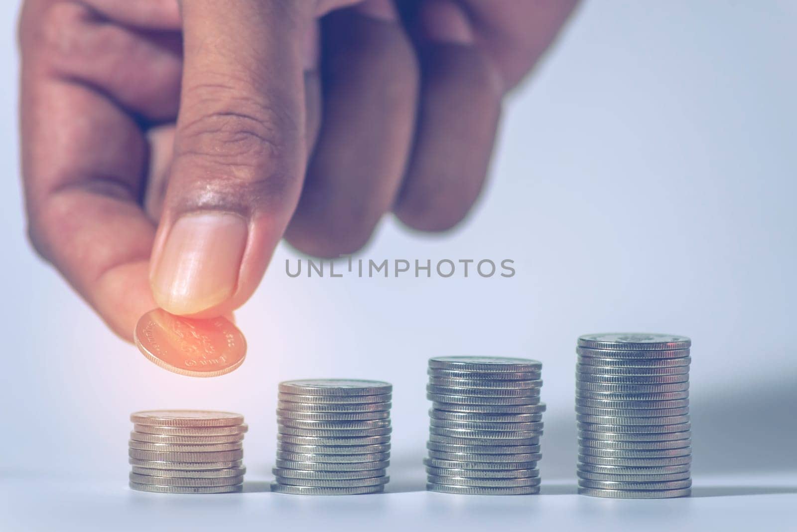 Save money and account banking for finance concept, Hand with coin on blurred background, Save Monney for Investors Using Internet to Trade Stocks or Trade Fund