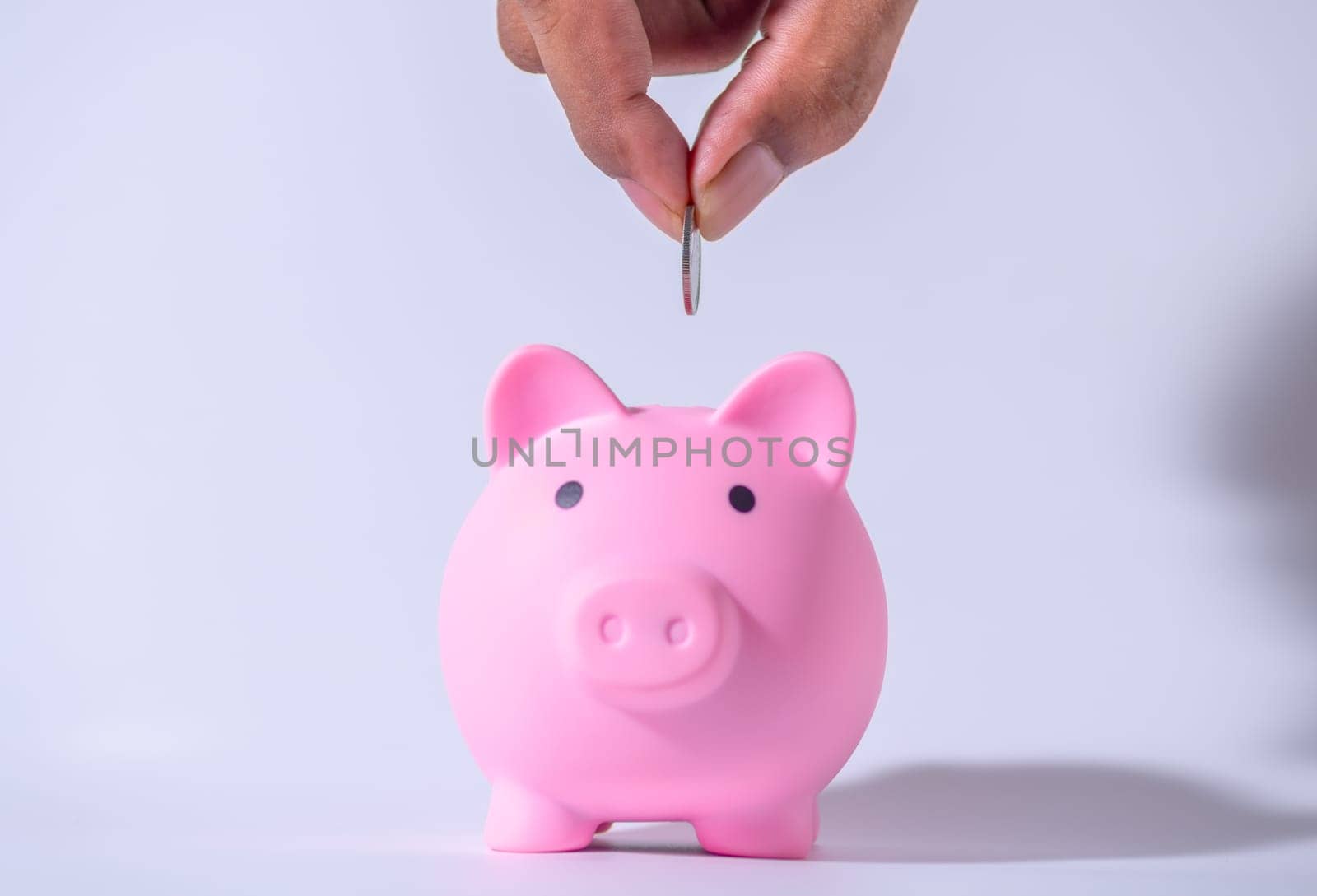 Save money and account banking for finance concept, Hand with piggy bank and coin on blurred background, Save Monney for Investors Using Internet to Trade Stocks or Trade Fund
