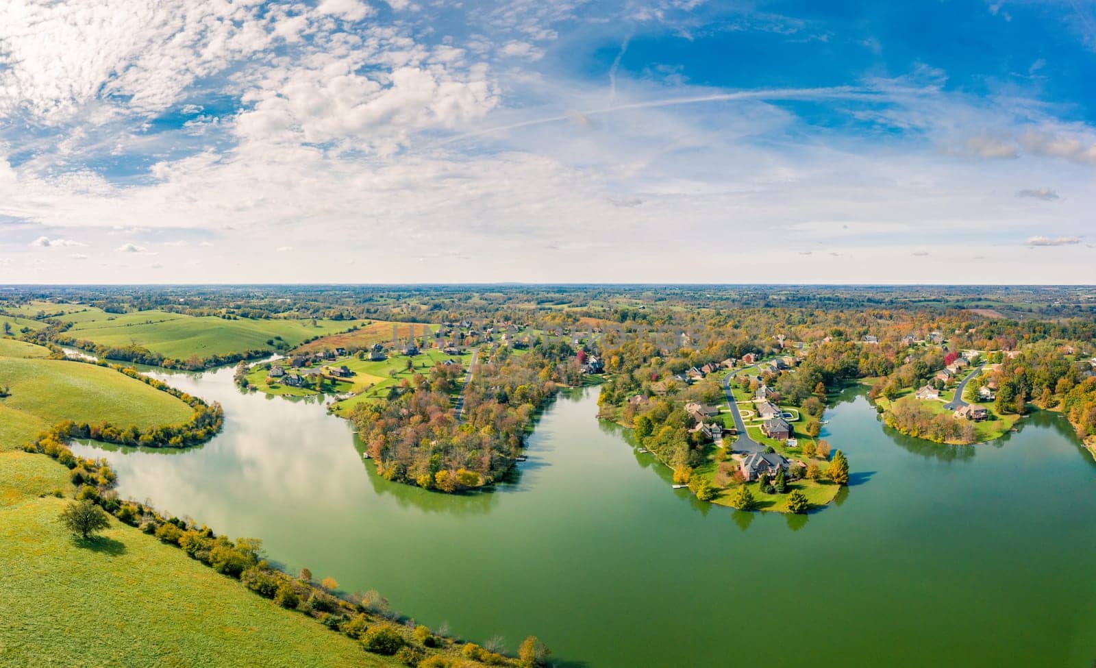 Aerial footage of residential subdivision by a lake in Central Kentucky in fall