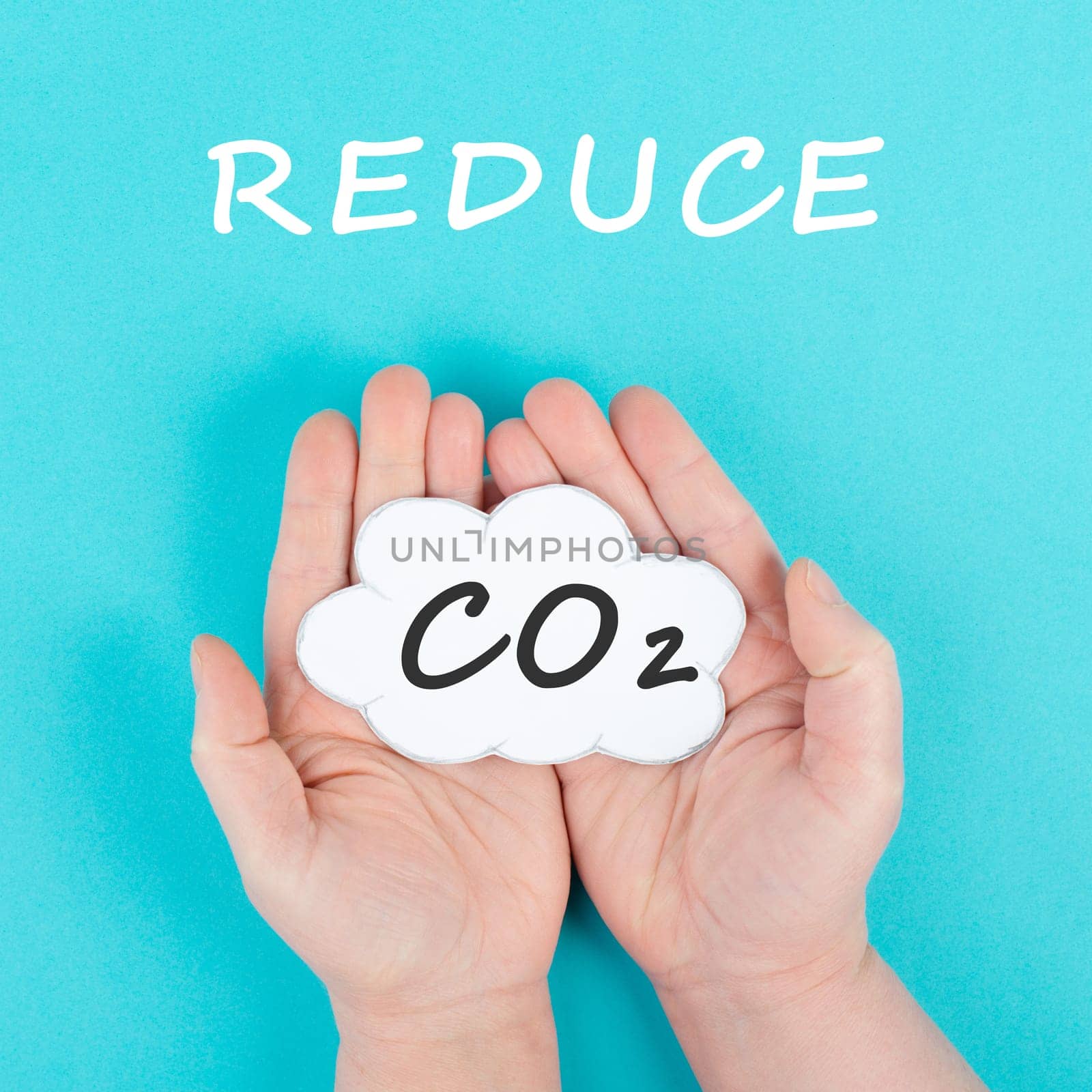 Hand holds cloud with the word CO 2, reduce carbon dioxide emission, environmental issue, air pollution