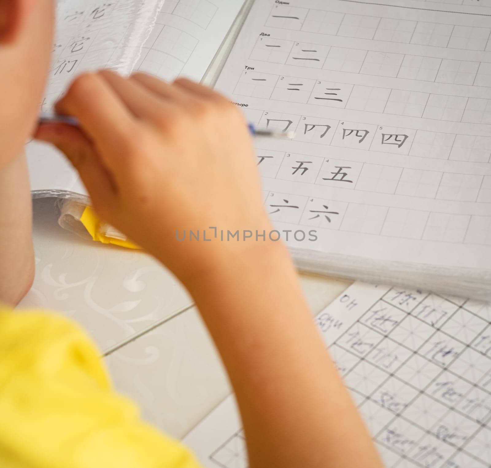 Boy learns chinese langruage and hieroglyphs editorial