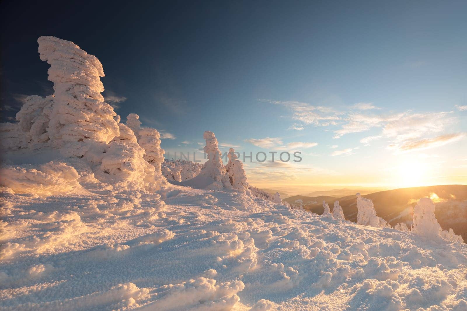 Winter scenery of the Sudetes Mountains on the Polish-Czech border during sunrise