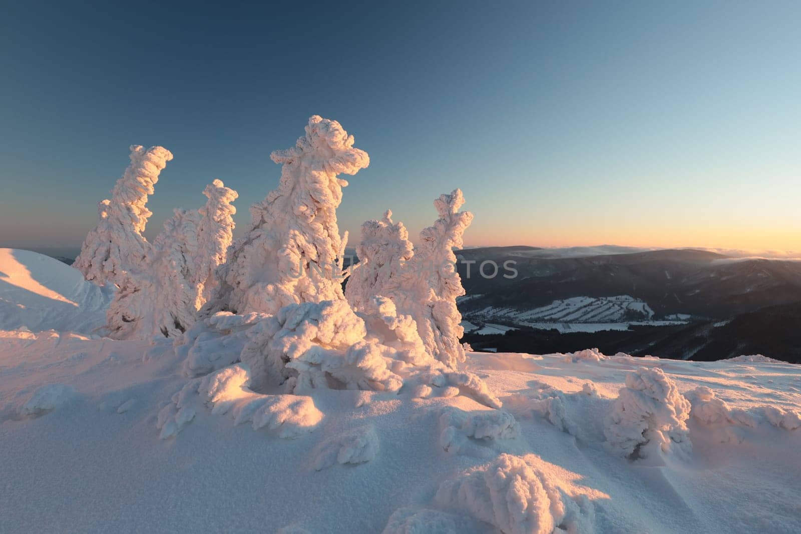 Winter scenery of the Sudetes Mountains on the Polish-Czech border during sunrise