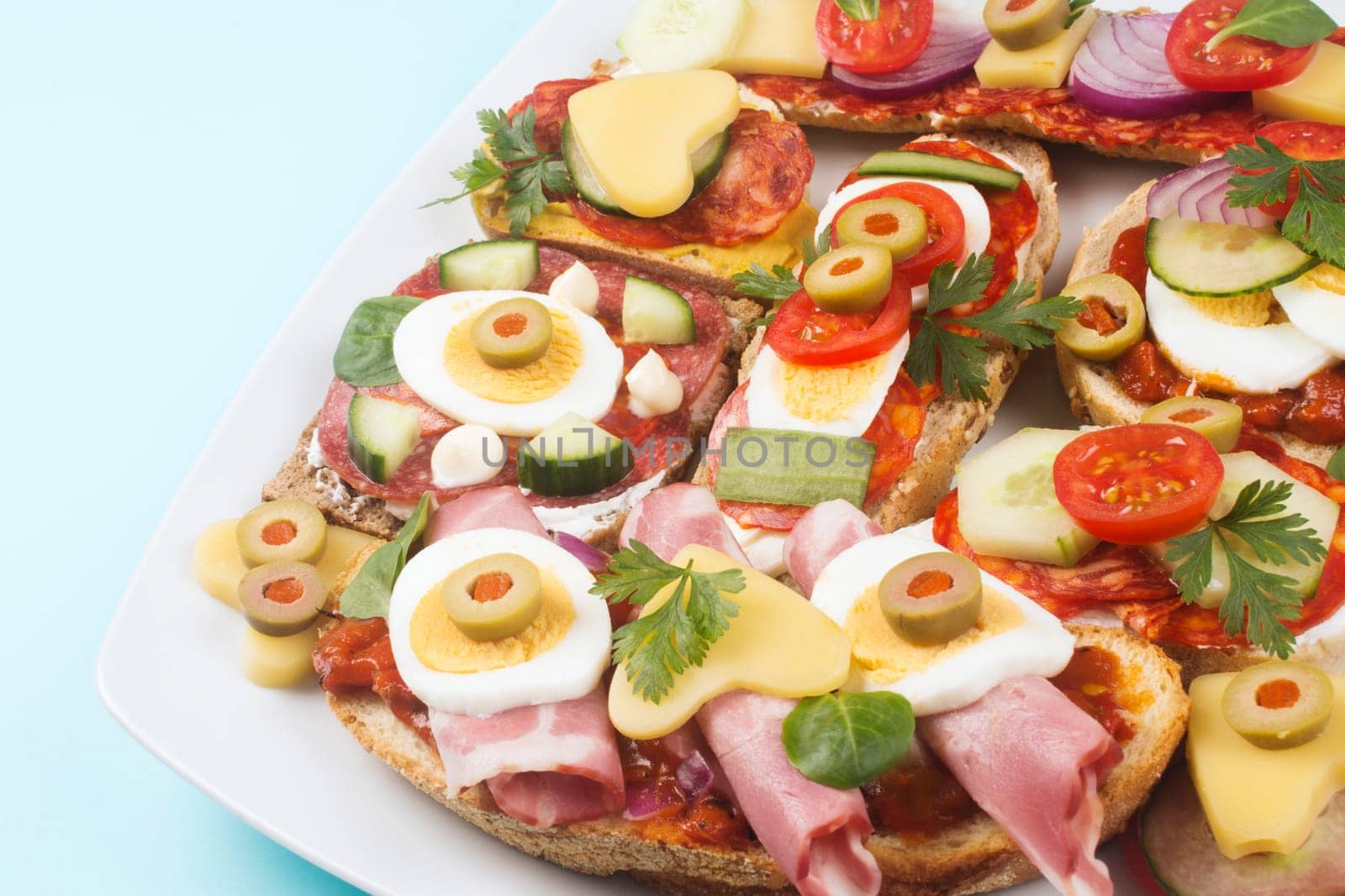 Brunch platter with decorated mini sandwiches, catering and food service industry.