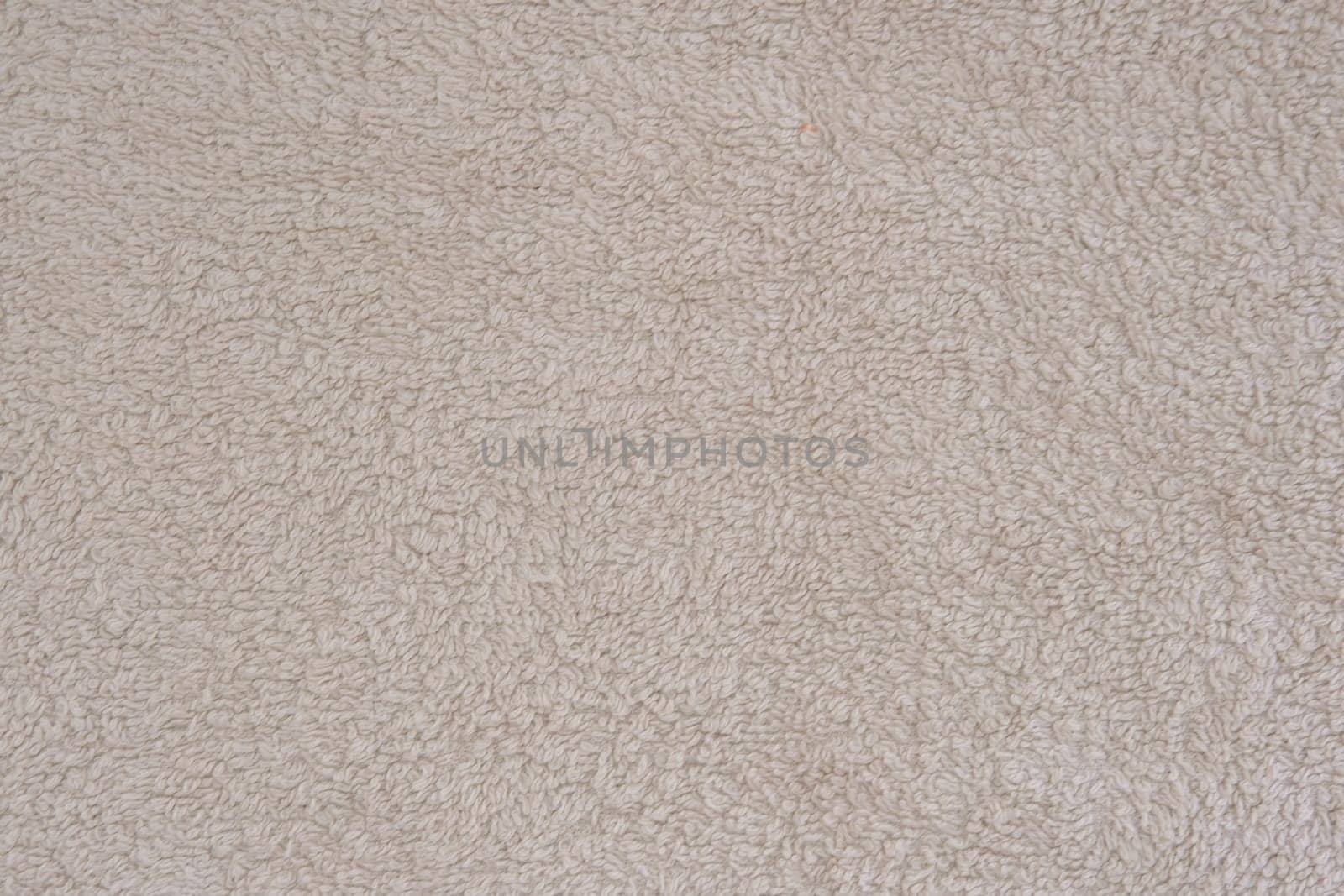 Fluffy gentle pastel biege fabric with waves and folds. Soft pastel textile texture