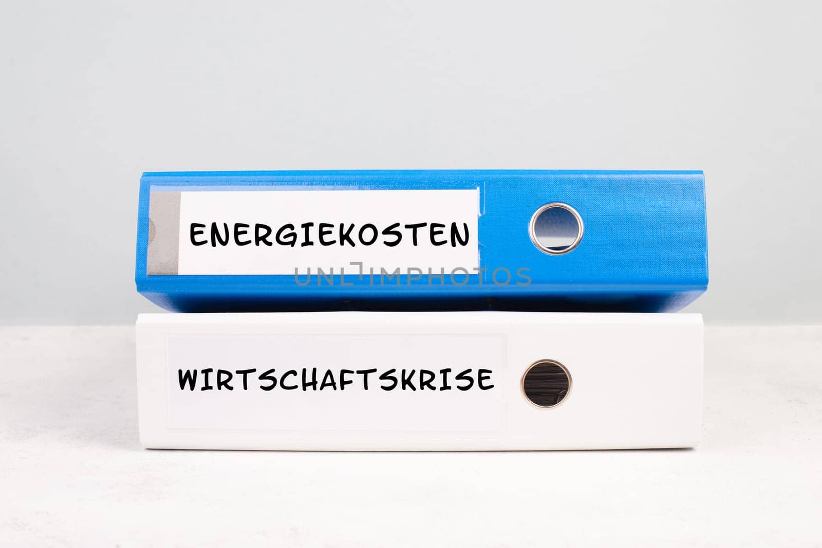 Energy prices and economic crisis are standing in german language on the folders, increasing prices , high living expenses, gas and electricity costs, inflation