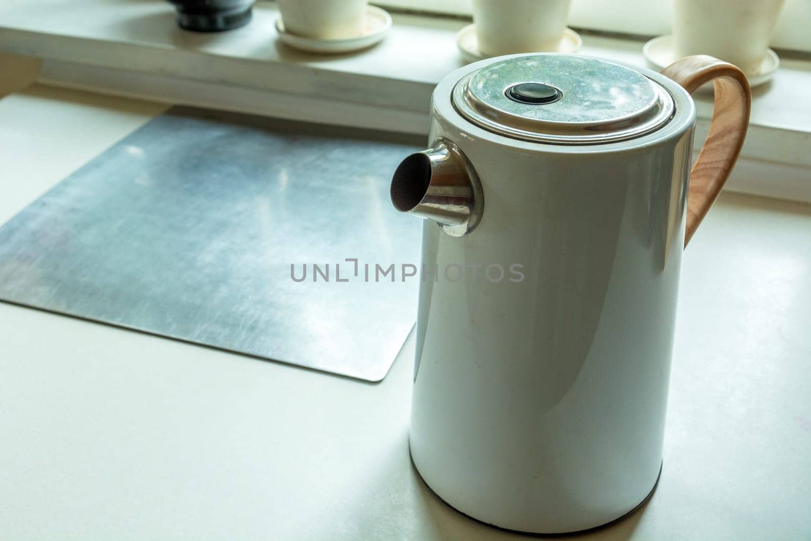 White electric kettle standing on the kitchen counter