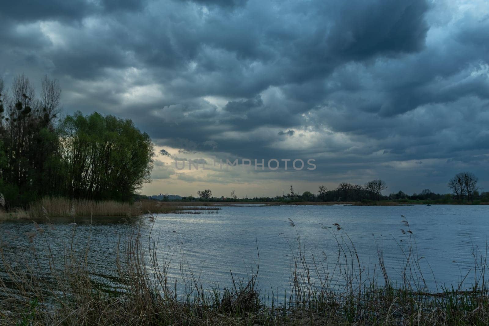 Dark storm clouds over the lake, spring view, Stankow, Poland